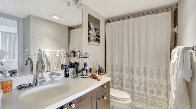 bathroom with toilet and vanity