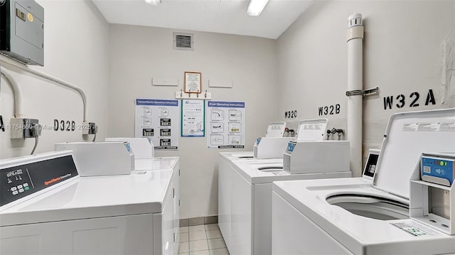 common laundry area featuring light tile patterned flooring, visible vents, and washing machine and clothes dryer