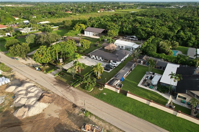 drone / aerial view with a wooded view