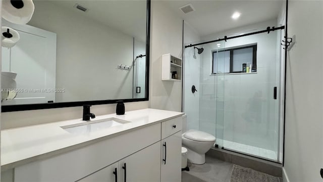 full bathroom featuring a stall shower, visible vents, vanity, and toilet