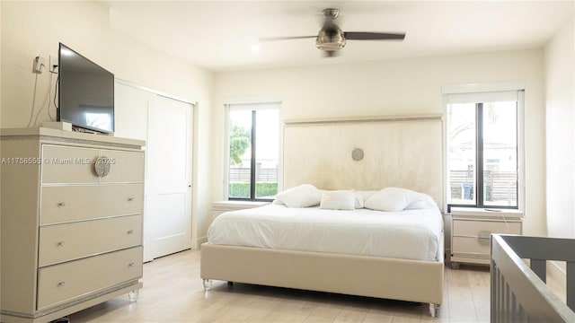 bedroom featuring ceiling fan and light wood-style flooring