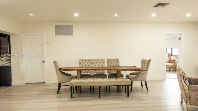 dining area featuring light wood finished floors, visible vents, and recessed lighting