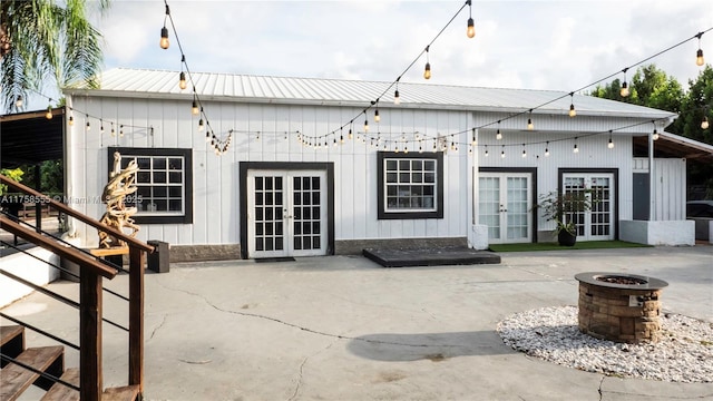 rear view of house with an outdoor fire pit, french doors, a patio area, and metal roof