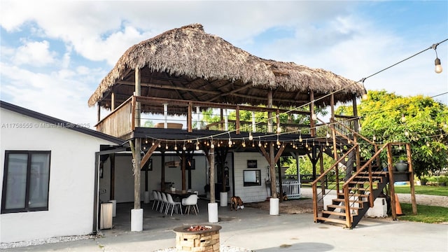 exterior space with stairs, a gazebo, a patio area, and stucco siding