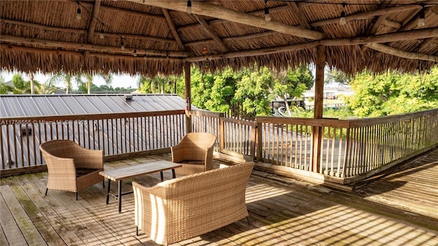 wooden terrace featuring a gazebo