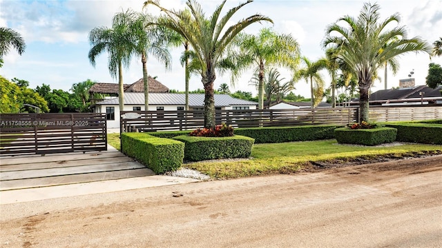 view of property's community featuring a fenced front yard and a gate