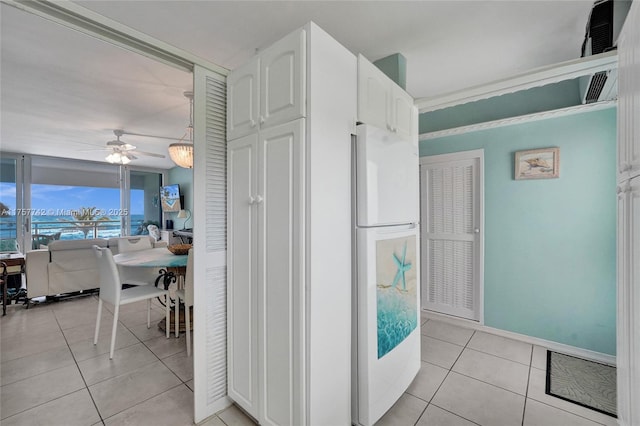 corridor featuring light tile patterned floors and baseboards