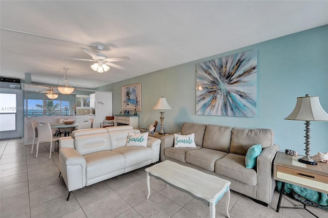 living area with ceiling fan and light tile patterned flooring