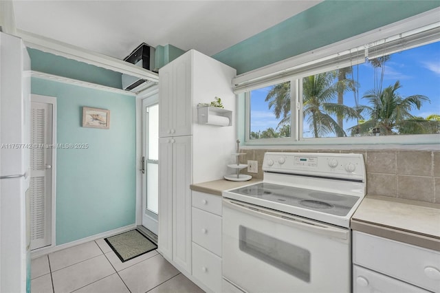 kitchen featuring tasteful backsplash, light countertops, and white electric stove