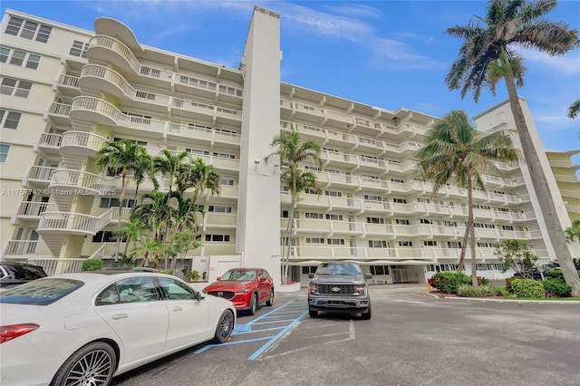 view of building exterior with uncovered parking