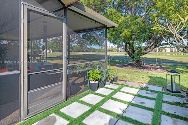 exterior space with a patio area and a sunroom