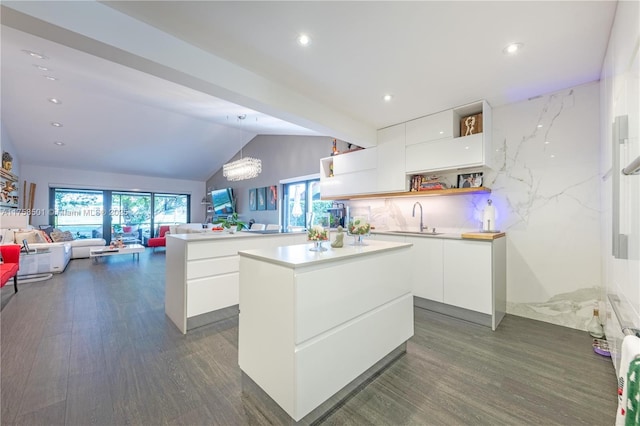 kitchen with open shelves, modern cabinets, white cabinets, and a sink