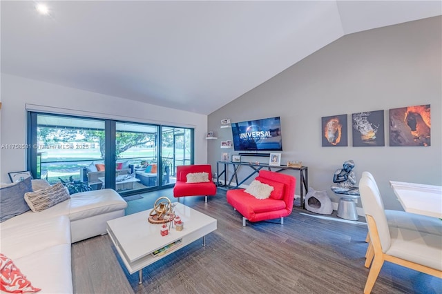 living room featuring high vaulted ceiling and wood finished floors