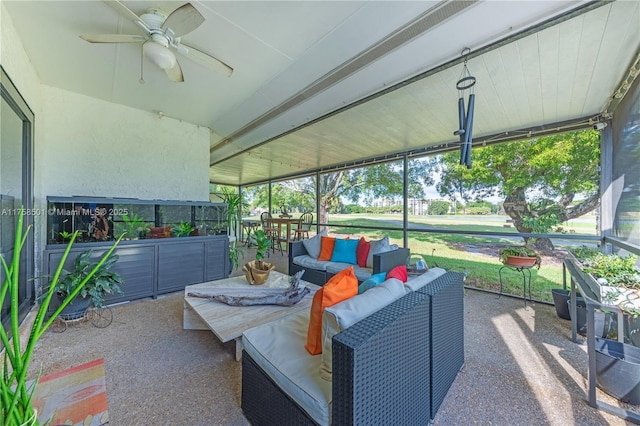 sunroom featuring ceiling fan