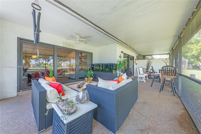 sunroom featuring ceiling fan