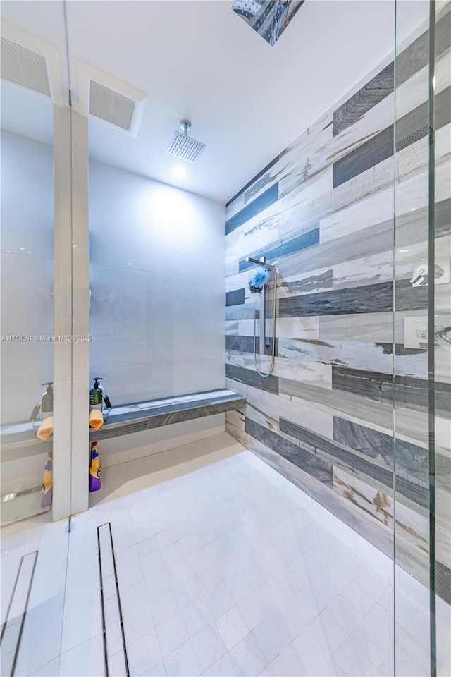 bathroom featuring visible vents and tiled shower