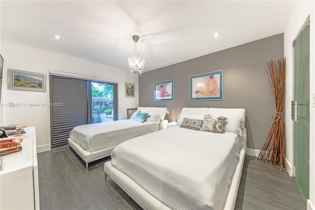 bedroom with recessed lighting, a chandelier, baseboards, and wood finished floors