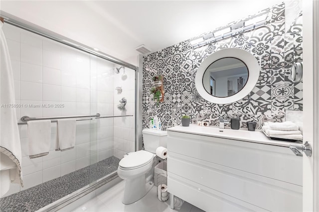 bathroom with visible vents, a shower stall, wallpapered walls, toilet, and vanity