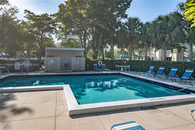 community pool featuring fence and a patio area