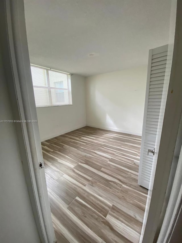 spare room with wood finished floors