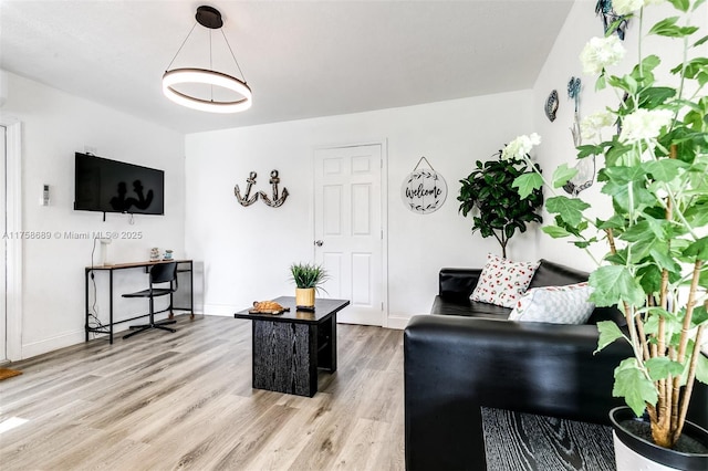 living area with light wood-style flooring and baseboards