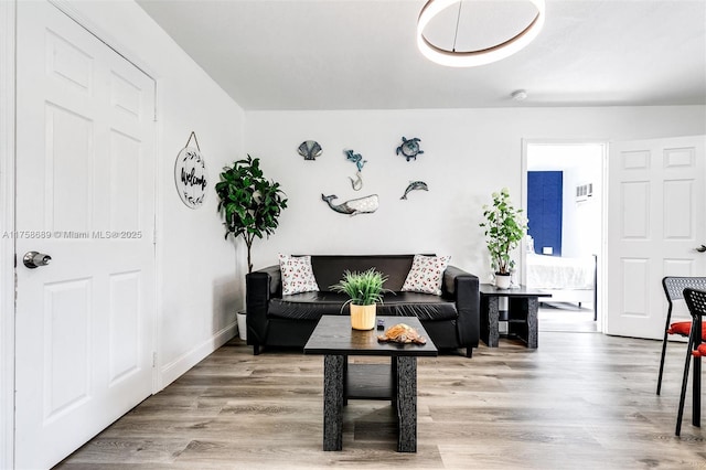 living area with wood finished floors and baseboards