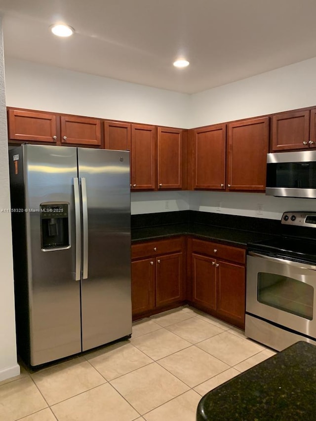 kitchen featuring recessed lighting, appliances with stainless steel finishes, and light tile patterned flooring