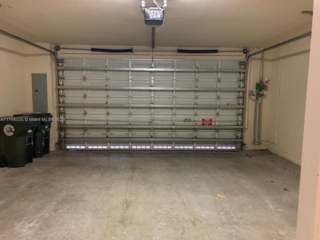 garage featuring electric panel and a garage door opener