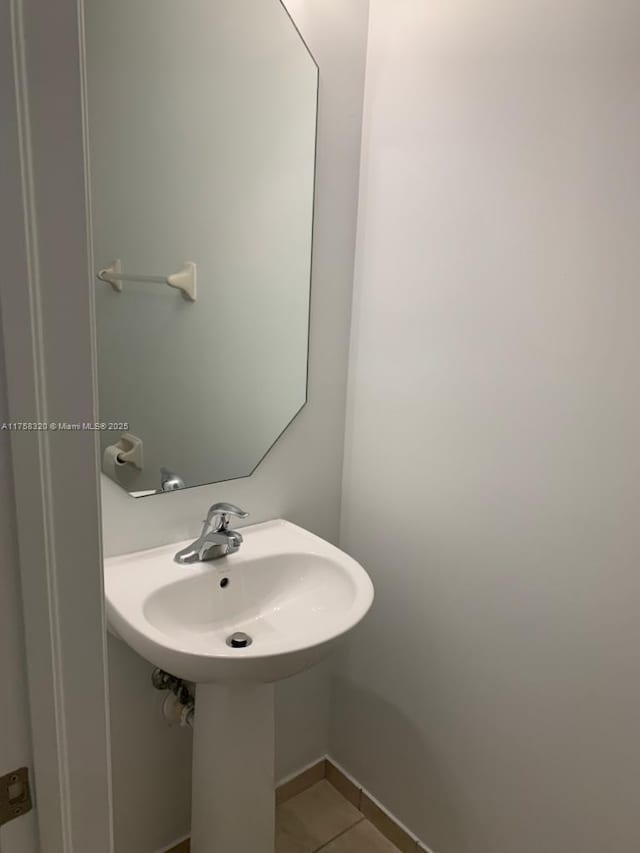 bathroom featuring tile patterned flooring and baseboards