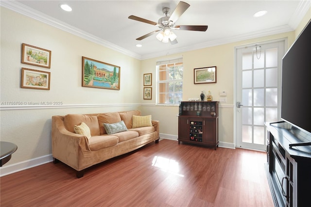 living area with crown molding, recessed lighting, a ceiling fan, and wood finished floors