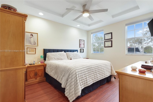 bedroom with ceiling fan, coffered ceiling, wood finished floors, and recessed lighting