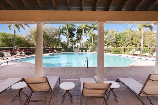 pool featuring fence and a patio