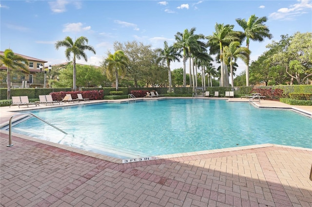 pool featuring fence and a patio