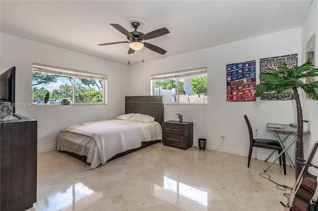 bedroom with baseboards, multiple windows, and a ceiling fan