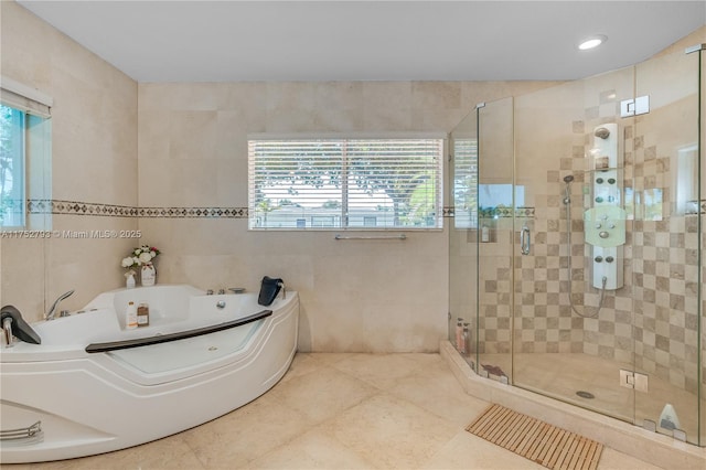 full bath with a shower stall, tile walls, a bath, and tile patterned floors