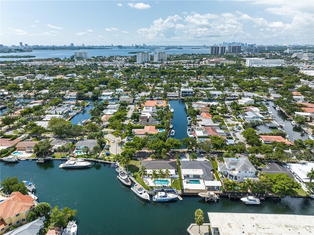birds eye view of property featuring a view of city and a water view