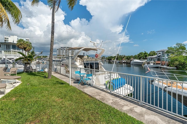 exterior space with a water view, a lawn, and fence