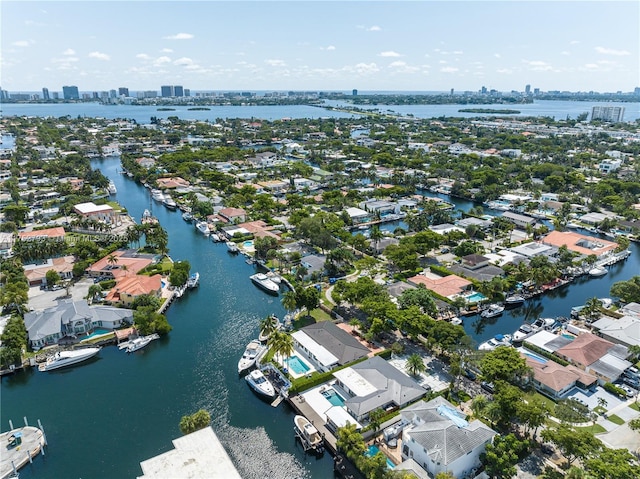 birds eye view of property featuring a city view and a water view