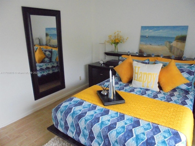 bedroom featuring wood finished floors and baseboards