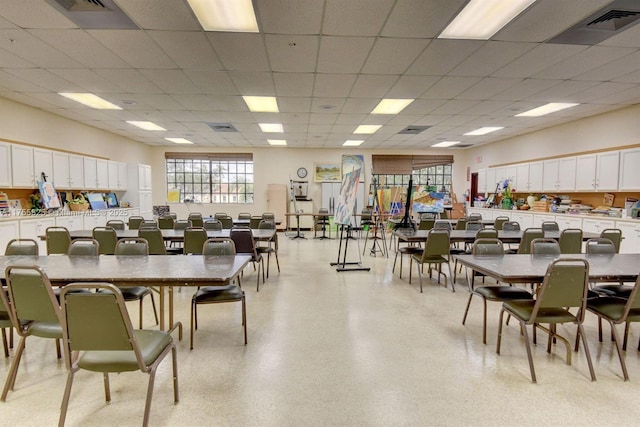 dining room with visible vents, light speckled floor, and a drop ceiling