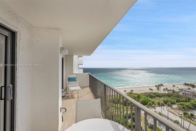 balcony with a water view and a beach view