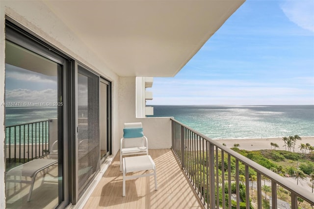 balcony featuring a water view and a view of the beach