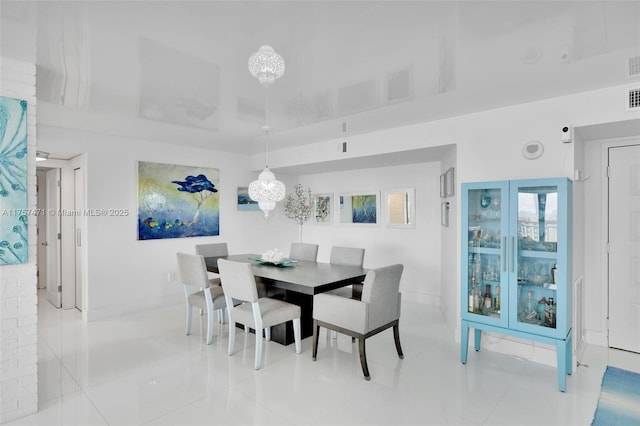 dining room with baseboards, visible vents, and tile patterned floors