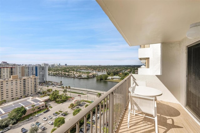 balcony featuring a water view and a city view