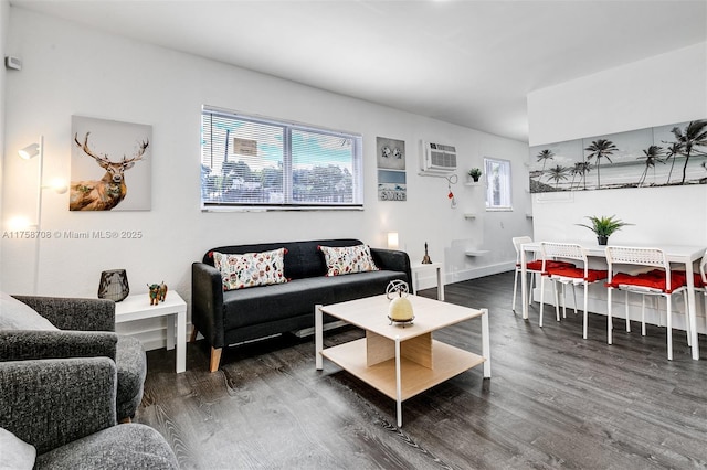 living area featuring a wealth of natural light, a wall mounted air conditioner, and wood finished floors