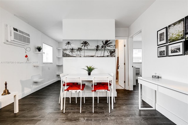 dining space featuring dark wood-style floors, an AC wall unit, and baseboards