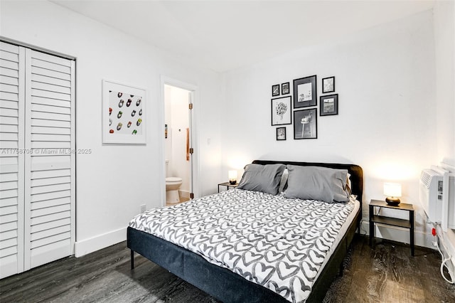 bedroom featuring a closet, baseboards, and dark wood-type flooring