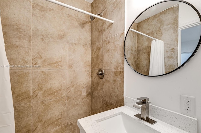 bathroom featuring a sink and a tile shower