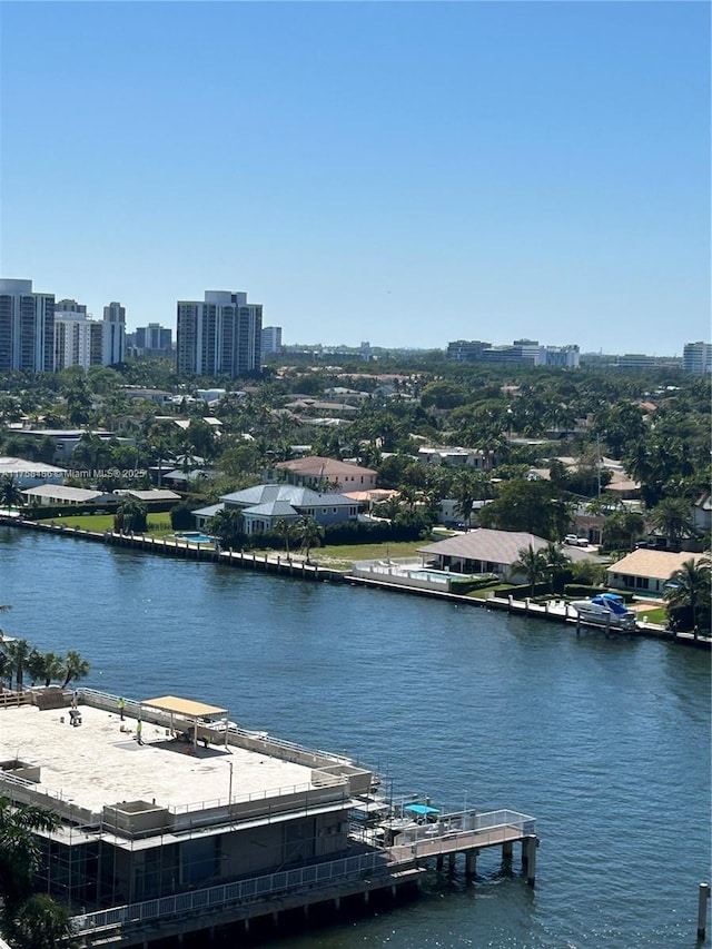 birds eye view of property featuring a water view and a city view