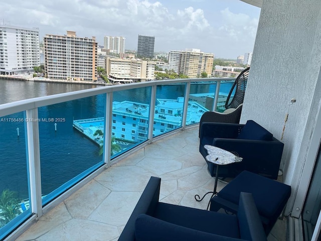 balcony with a view of city and a water view